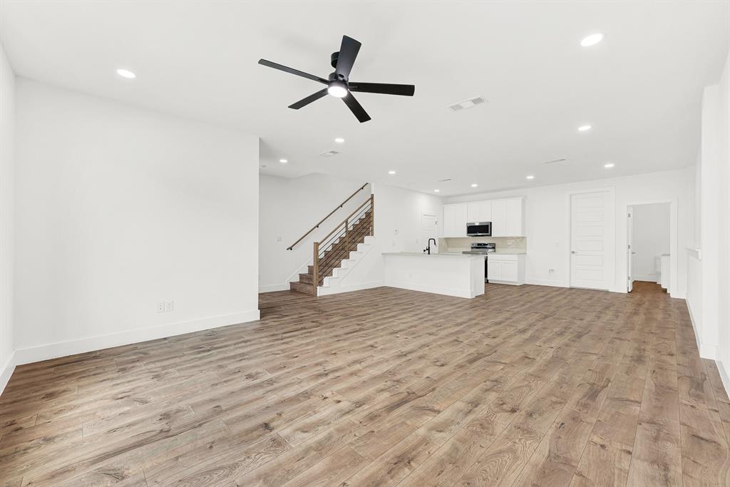9471 Timberleaf Drive Dallas, TX 75243 - Photo 16 of 39 Open-concept living area featuring wood-finish flooring, recessed lighting, and a contemporary ceiling fan