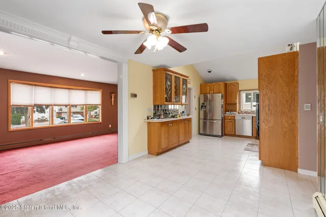 a view of a kitchen with a sink and refrigerator