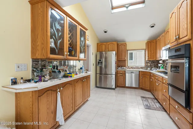 a kitchen with stainless steel appliances a refrigerator sink and cabinets