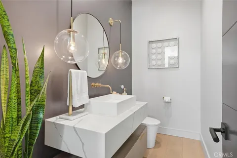 a bathroom with a sink a toilet and a mirror