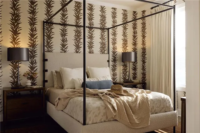 a bedroom with a bed and lamp on the dresser