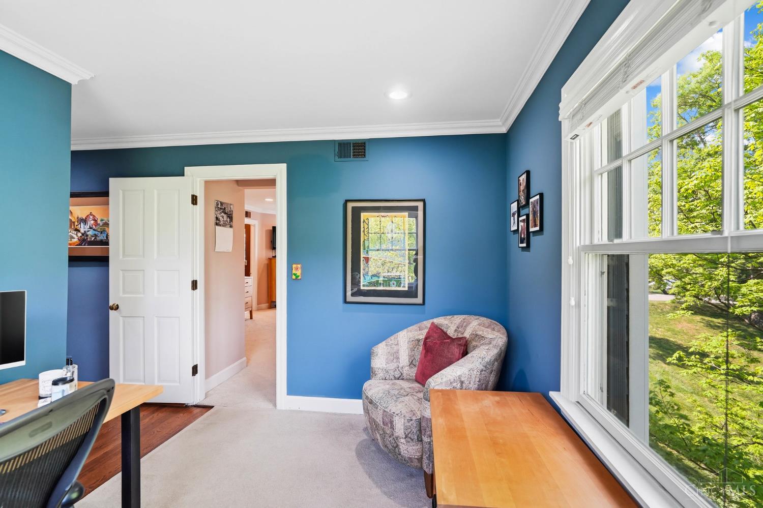 2780 Walsh Road Cincinnati, OH 45208 - Photo 28 of 68 The spacious primary suite serves as a true retreat, offering generous proportions, soft natural light, and a calming, neutral palette. The bedroom easily accommodates full furnishings with room to spare, creating an inviting and restful atmosphere. An adjoining sitting room provides the perfect flex space for a home office, reading nook, or private lounge, while the expansive walk-in closet delivers exceptional storage and organization. The suite is further complemented by an ensuite bath, completing this comfortable and well-appointed primary sanctuary.