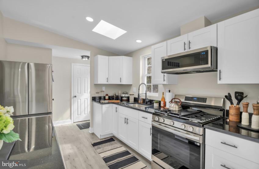 1230 Winslow Road Williamstown, NJ 08094 - Photo 18 of 34 a kitchen with stainless steel appliances a stove microwave and a refrigerator