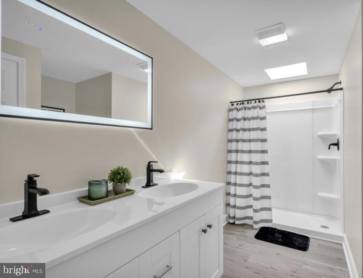 1230 Winslow Road Williamstown, NJ 08094 - Photo 24 of 34 a bathroom with a sink a vanity and a shower