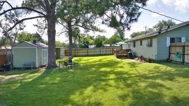 a view of a backyard with a garden and trees