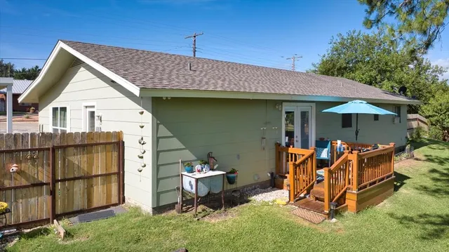 a view of a chairs and table in backyard of the house