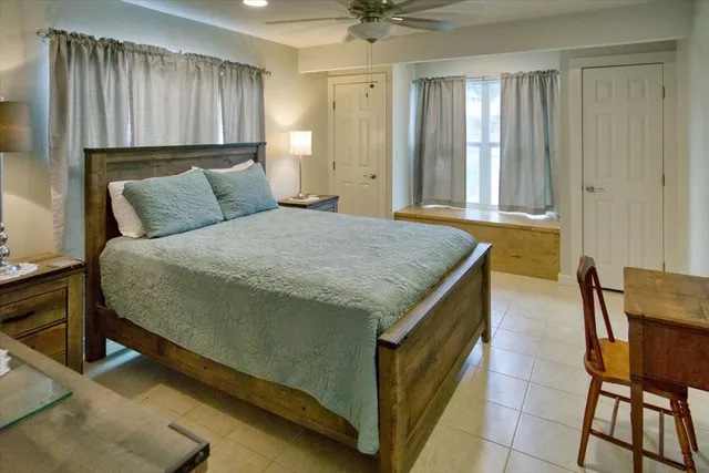 a spacious bedroom with a bed and a table in it