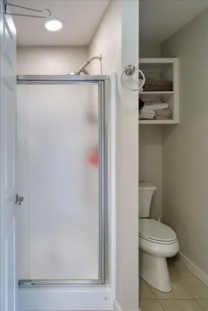 a bathroom with a toilet and a shower