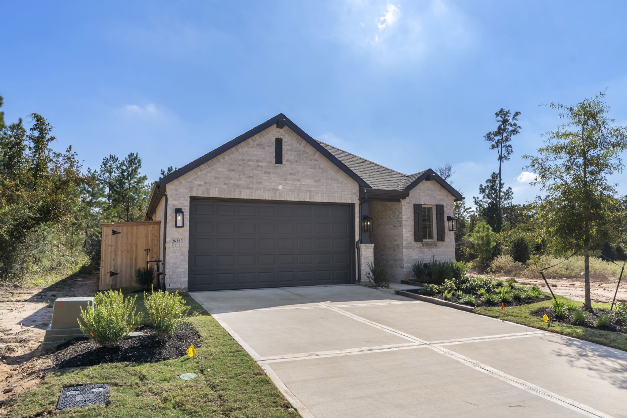 26383 Golden Pass Loop Montgomery, TX 77316 - Photo 2 of 40 a front view of a house with a yard and garage