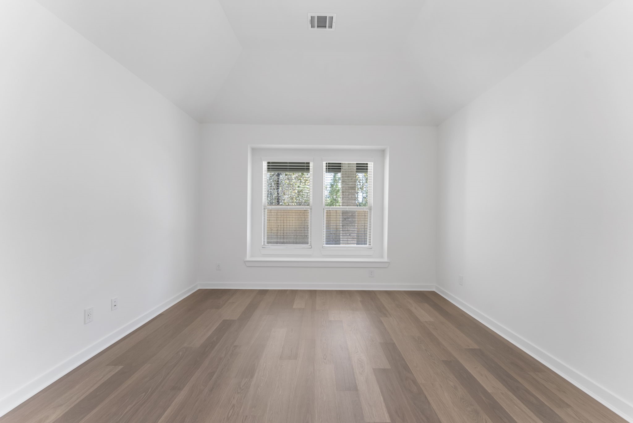 26383 Golden Pass Loop Montgomery, TX 77316 - Photo 27 of 40 an empty room with wooden floor and windows