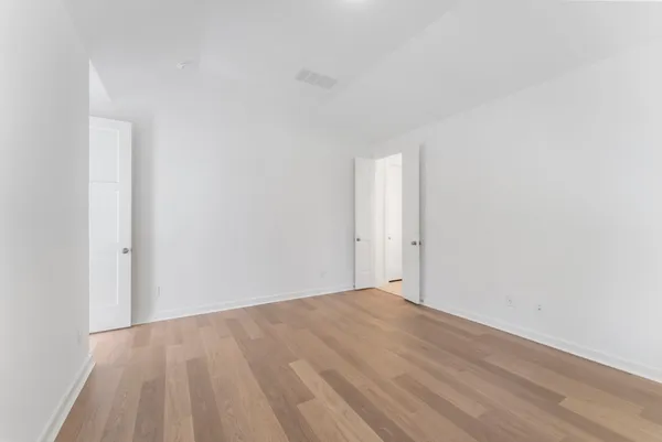 a spacious bathroom with a bathtub double sink shower and mirror