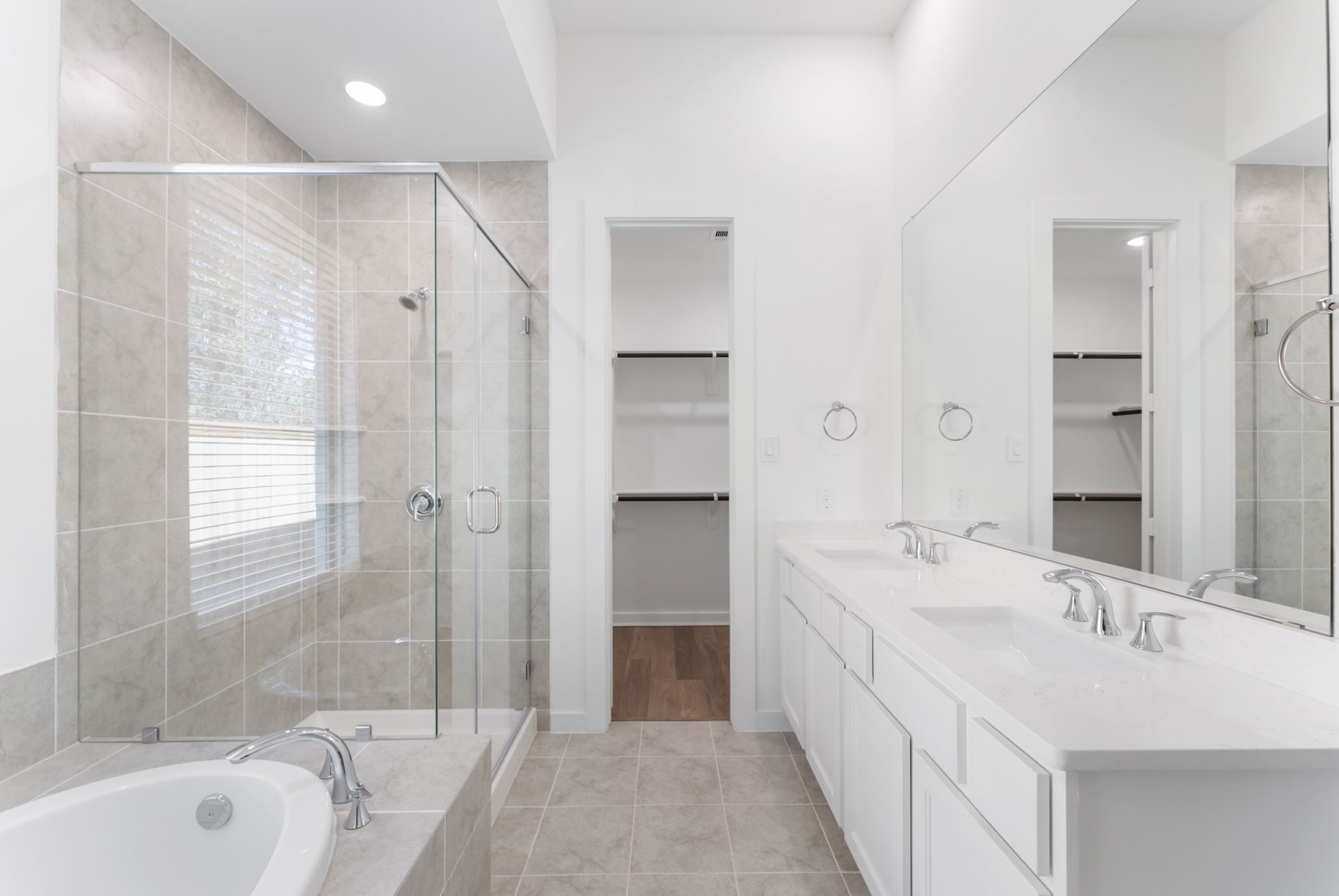 26383 Golden Pass Loop Montgomery, TX 77316 - Photo 29 of 40 a spacious bathroom with a bathtub double sink shower and mirror