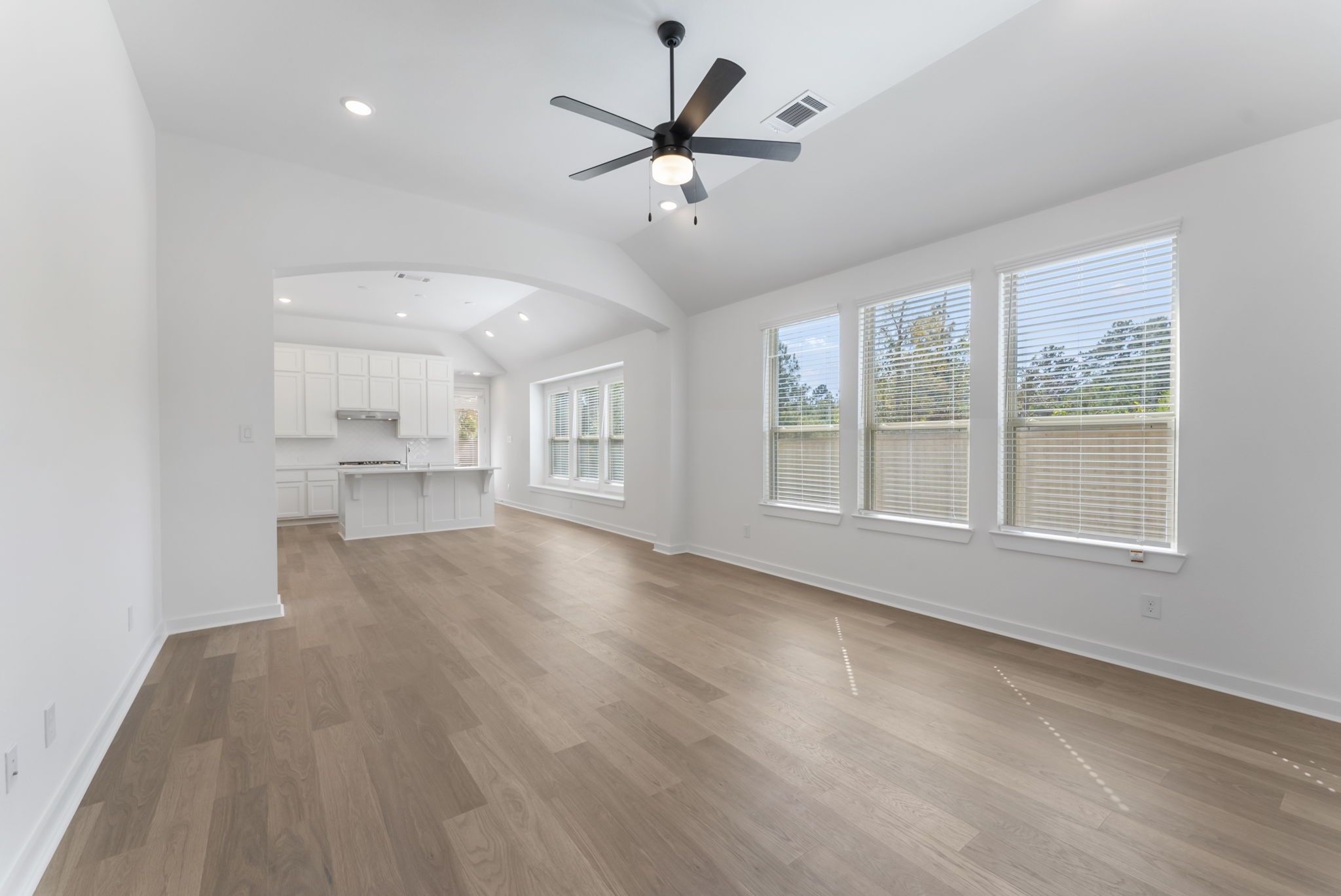 26383 Golden Pass Loop Montgomery, TX 77316 - Photo 9 of 40 a view of an empty room with a window and wooden floor