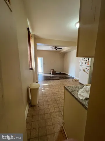 a kitchen with a sink a stove top oven and cabinetry