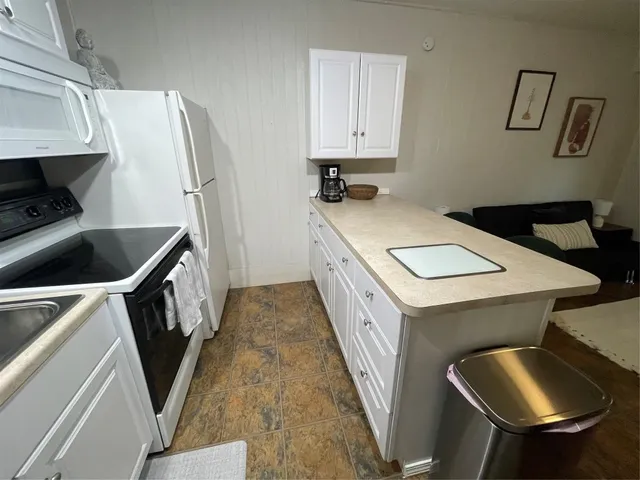a kitchen with sink refrigerator and stove