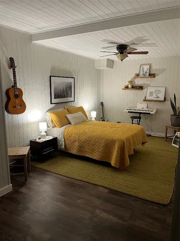 a bedroom with a bed and a chandelier