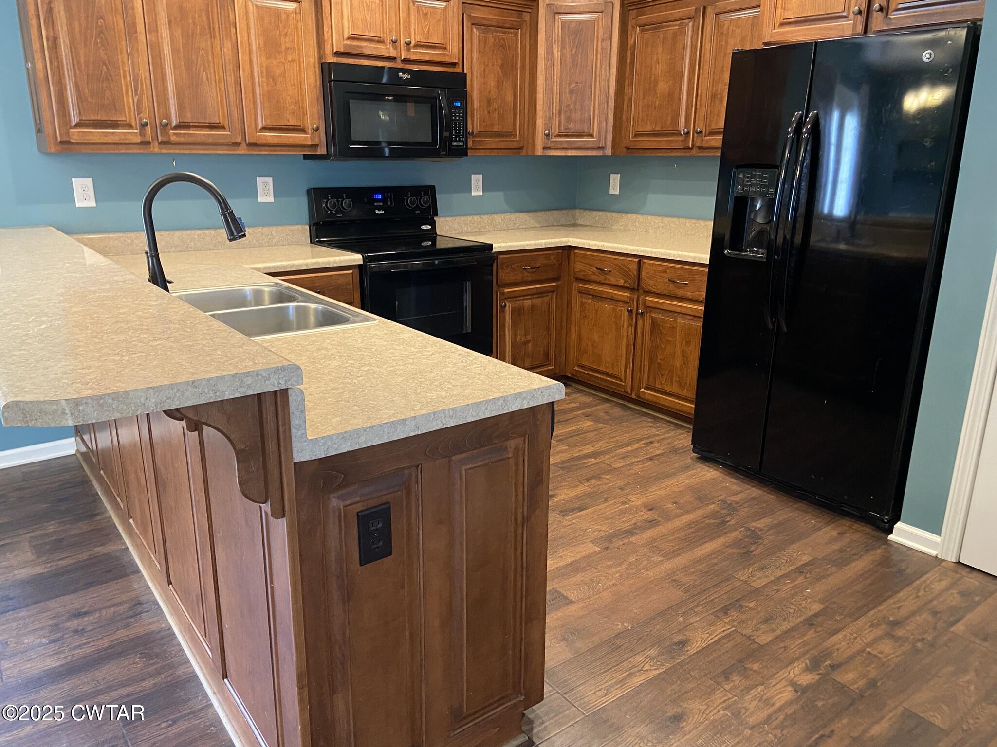 90 Timber Ridge Cove Henderson, TN 38340 - Photo 14 of 30 a kitchen with stainless steel appliances granite countertop a refrigerator a stove top oven a sink and dishwasher