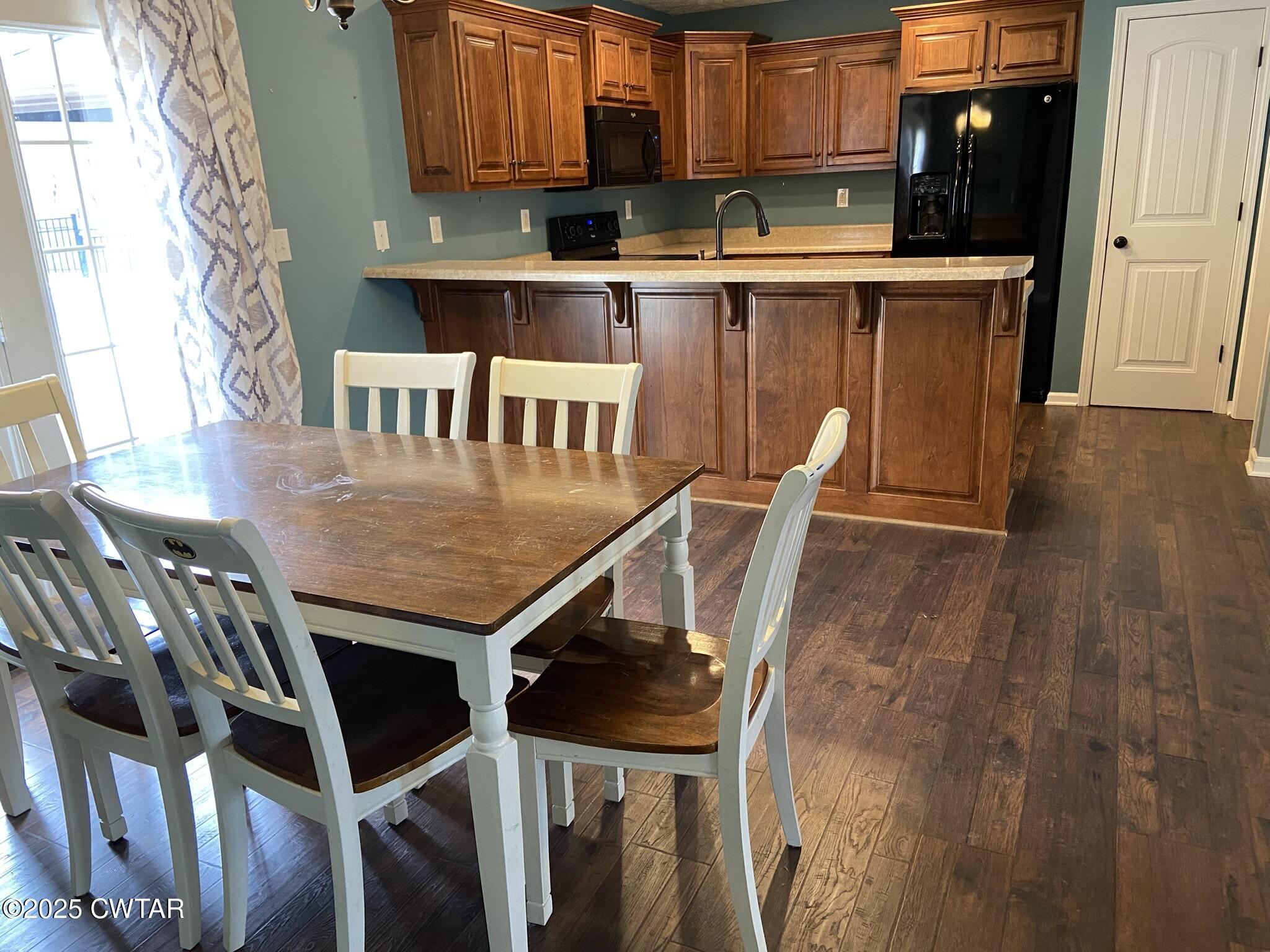 90 Timber Ridge Cove Henderson, TN 38340 - Photo 16 of 30 a kitchen with a table chairs and a refrigerator