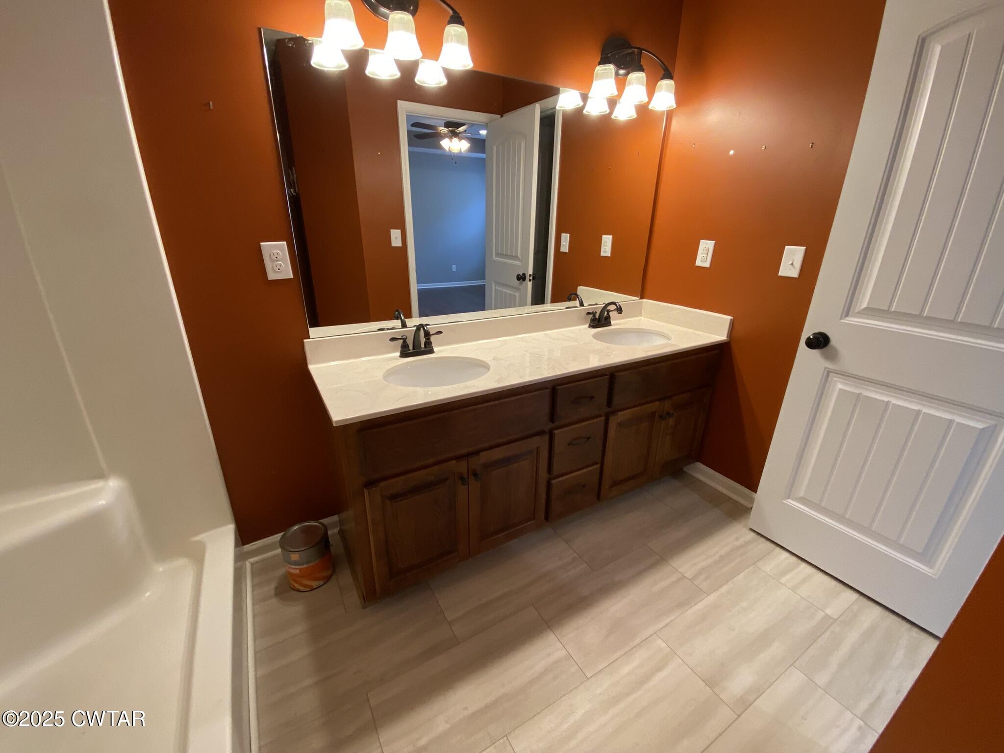 90 Timber Ridge Cove Henderson, TN 38340 - Photo 18 of 30 a bathroom with a double vanity sink and a mirror