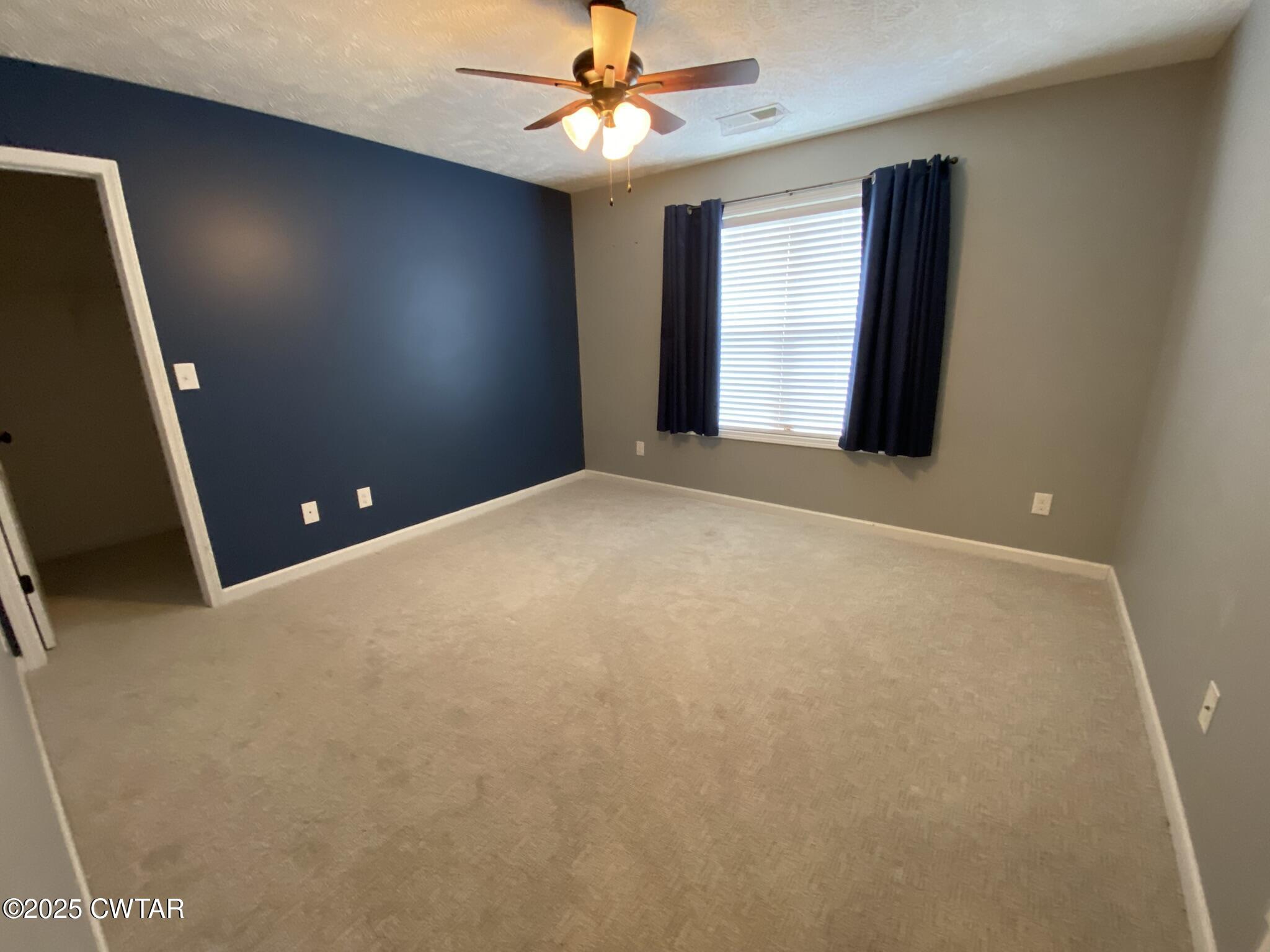90 Timber Ridge Cove Henderson, TN 38340 - Photo 23 of 30 en empty room with windows and fan