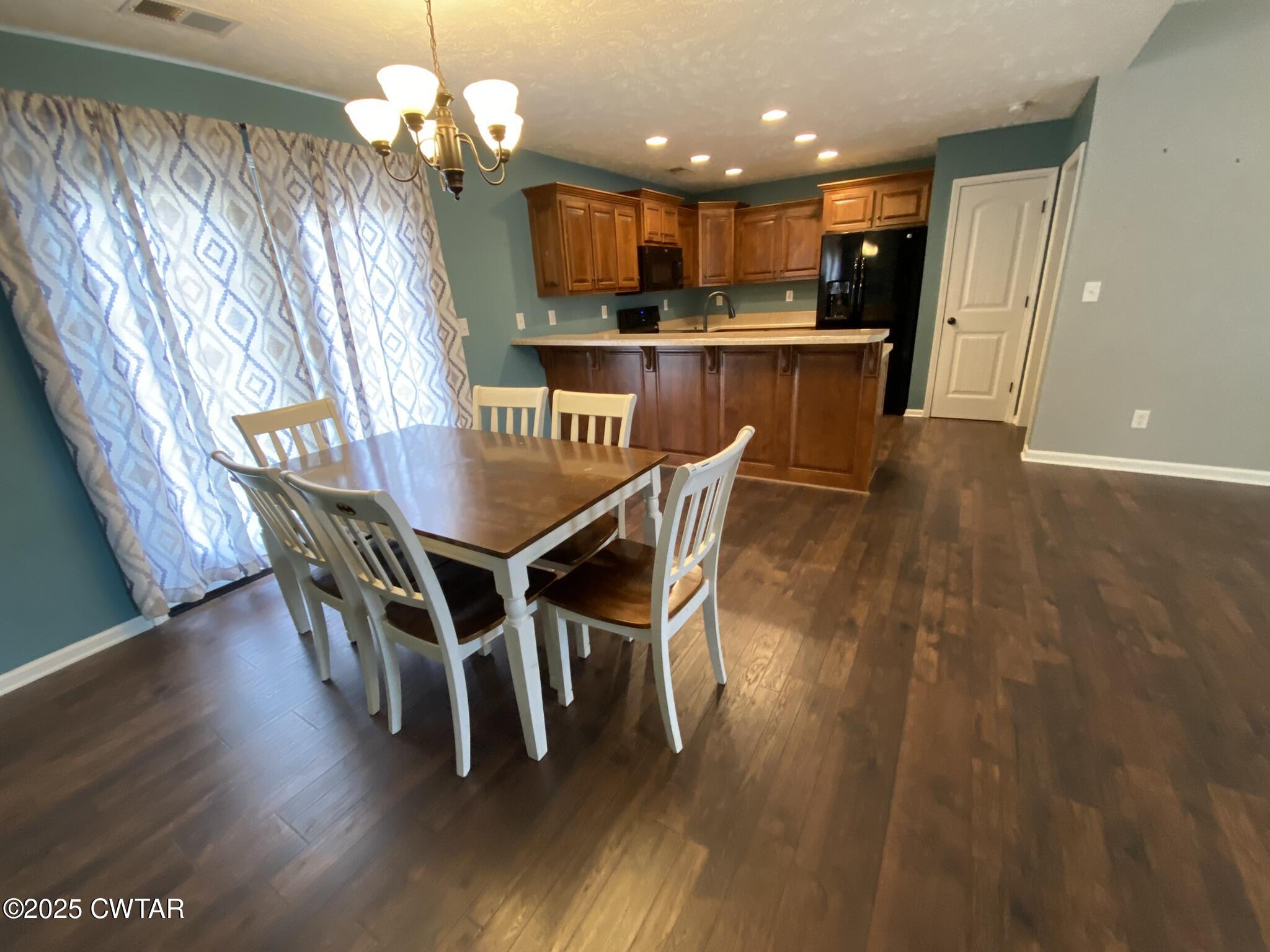 90 Timber Ridge Cove Henderson, TN 38340 - Photo 29 of 30 a dining room with furniture a chandelier and wooden floor