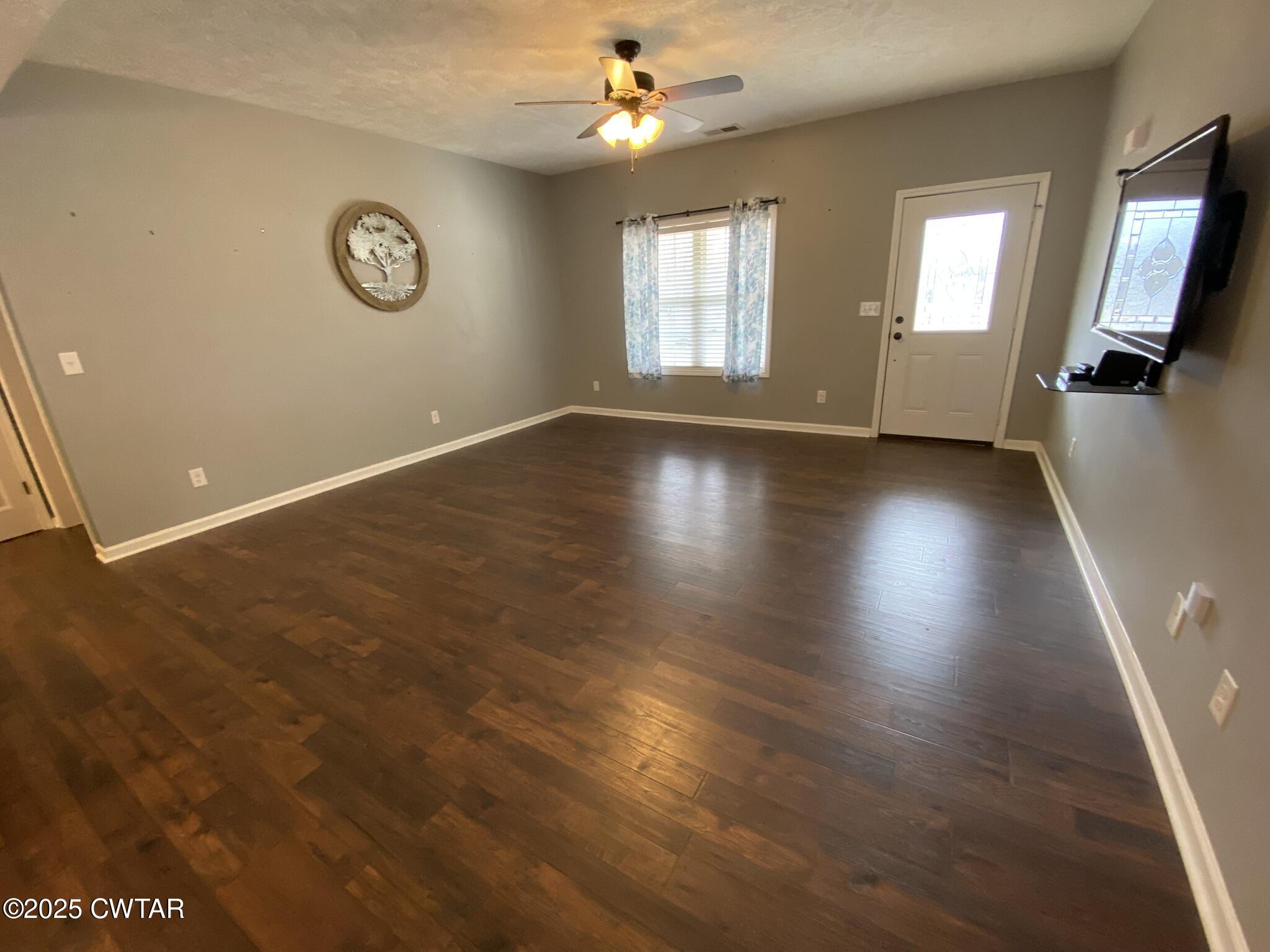 90 Timber Ridge Cove Henderson, TN 38340 - Photo 30 of 30 an empty room with wooden floor and windows