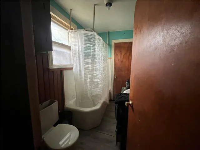 a bathroom with a toilet a sink and bathtub