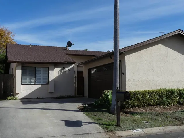 a front view of a building with a garden