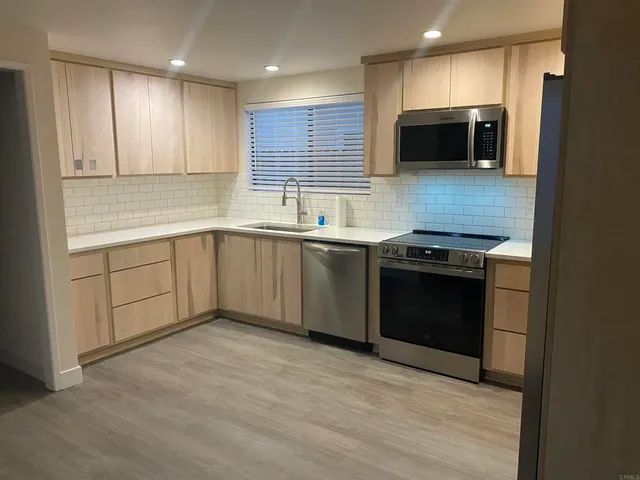 a view of a livingroom with wooden floor and a window