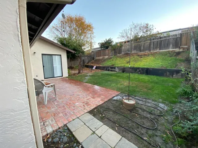 a view of a backyard with a patio and deck