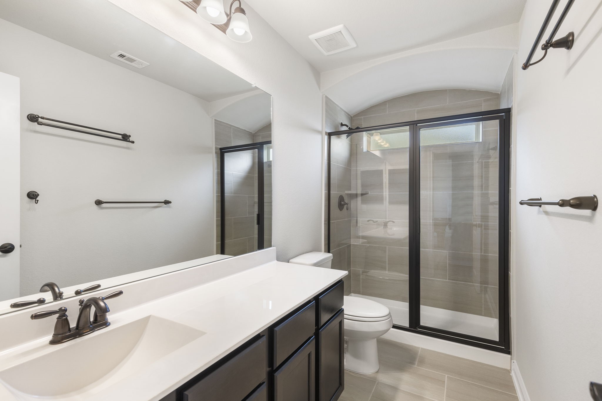 2819 Bradbury Hills Road Spring, TX 77373 - Photo 41 of 50 Discover modern elegance in Bathroom 2, featuring a sleek glass-enclosed shower, stylish fixtures, and ample counter space for a luxurious yet functional retreat.