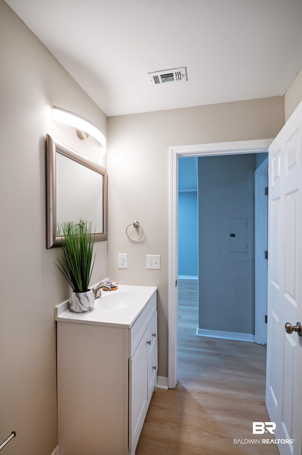 13474 Rooster Lane Foley, AL 36535 - Photo 29 of 39 Bathroom featuring vanity, wood finished floors, visible vents, and baseboards