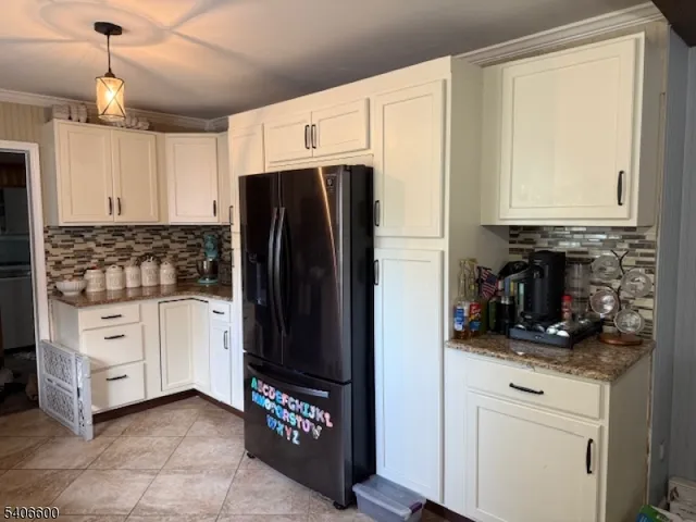 a kitchen with stainless steel appliances a refrigerator sink and cabinets