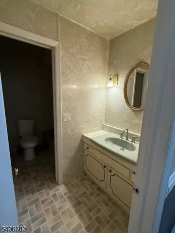 a bathroom with a sink a toilet and a shower