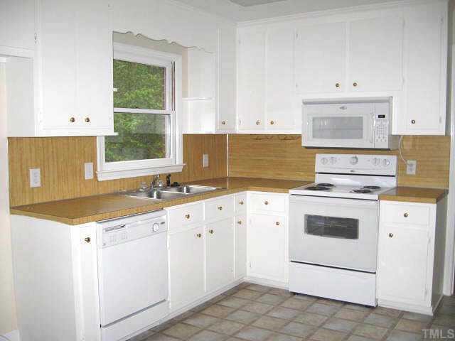 Large kitchen with white cabinets & new appliances