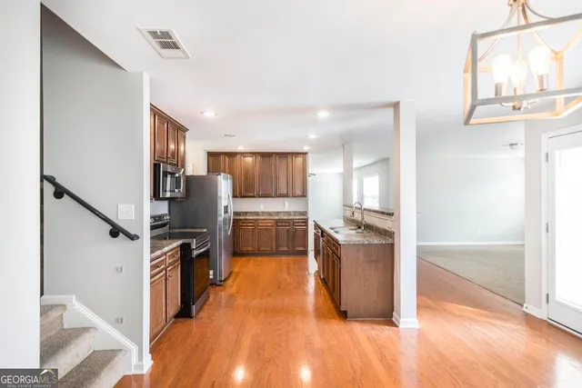 a kitchen with refrigerator and cabinets