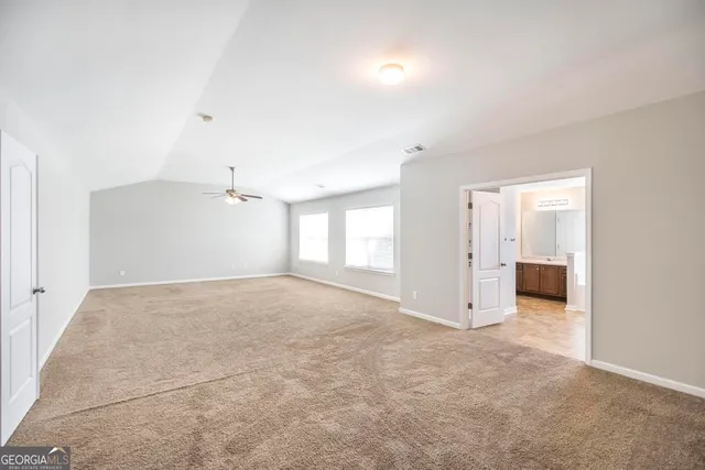 an empty room with windows and natural light