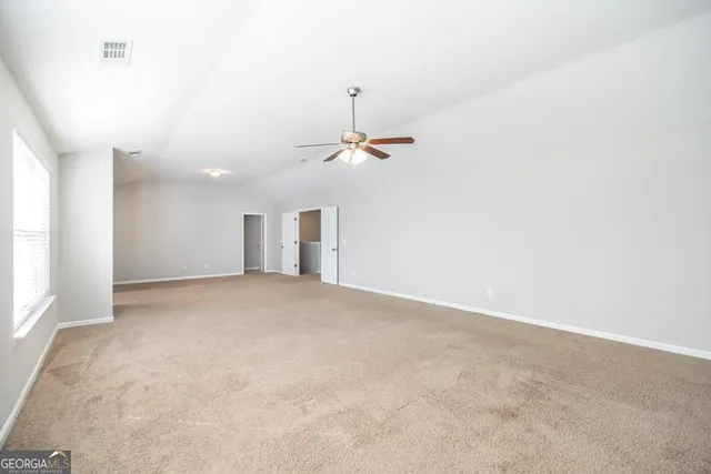 a view of a room with a ceiling fan