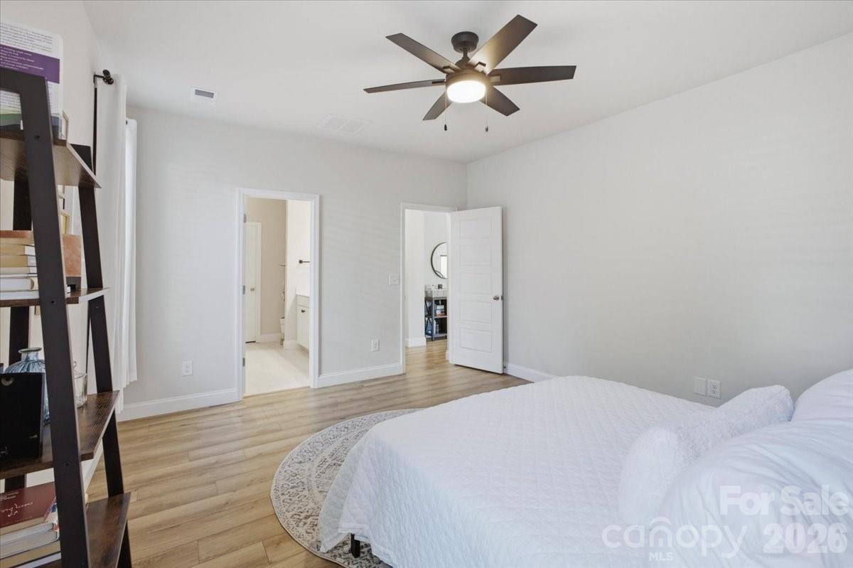 602 Banter Lane Cramerton, NC 28056 - Photo 13 of 33 a bedroom with a large bed and a chandelier