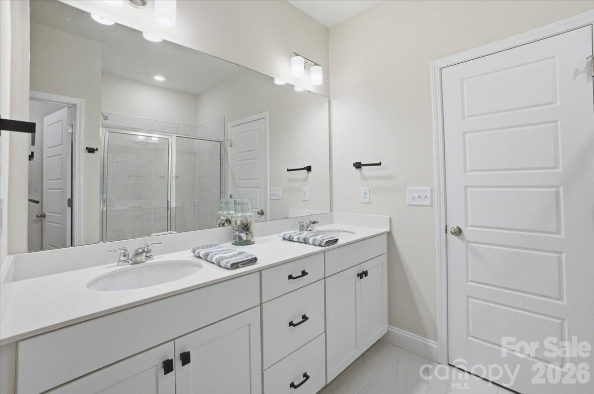602 Banter Lane Cramerton, NC 28056 - Photo 15 of 33 a bathroom with a double vanity sink and mirror