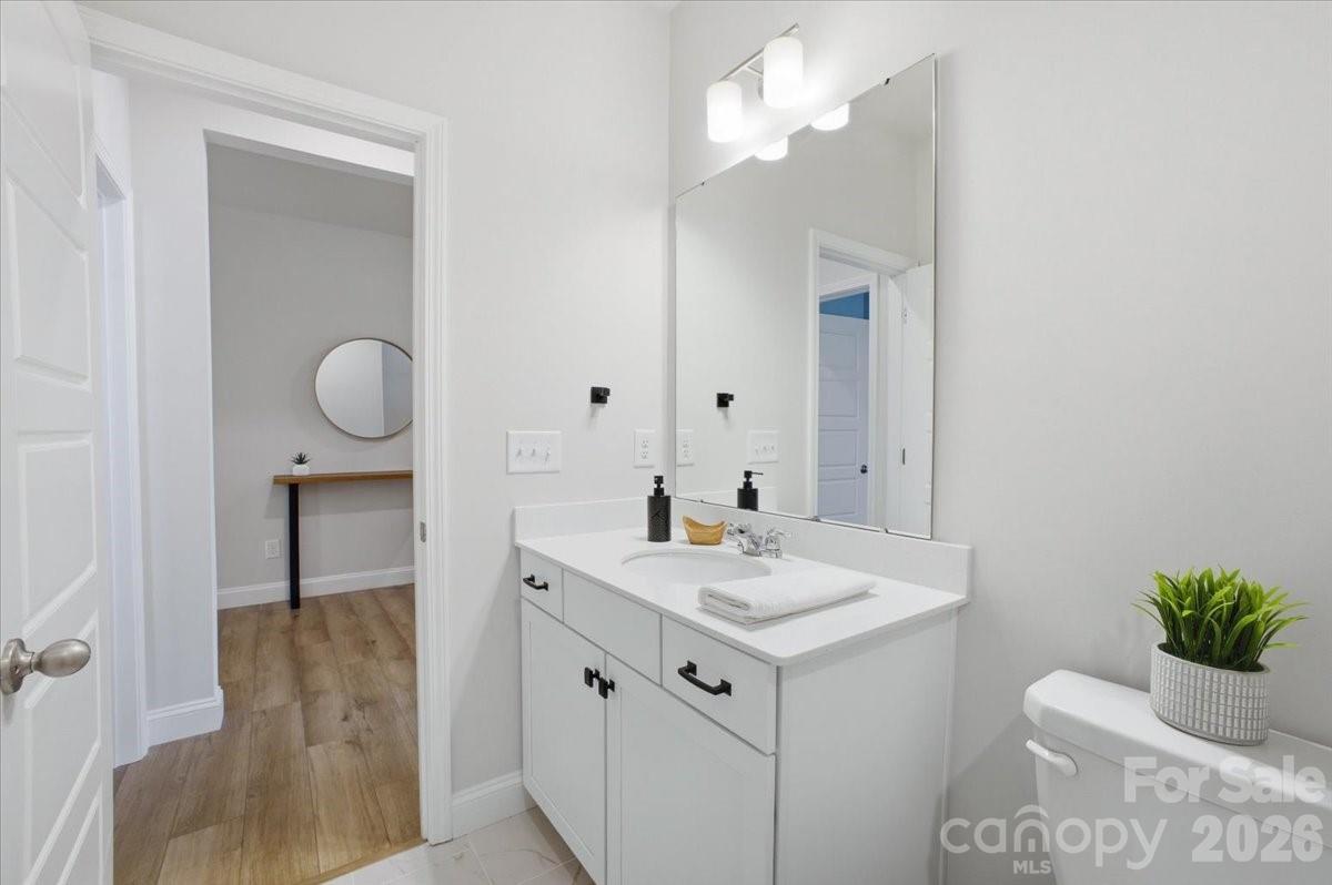 602 Banter Lane Cramerton, NC 28056 - Photo 22 of 33 a bathroom with a sink a light fixture and a mirror