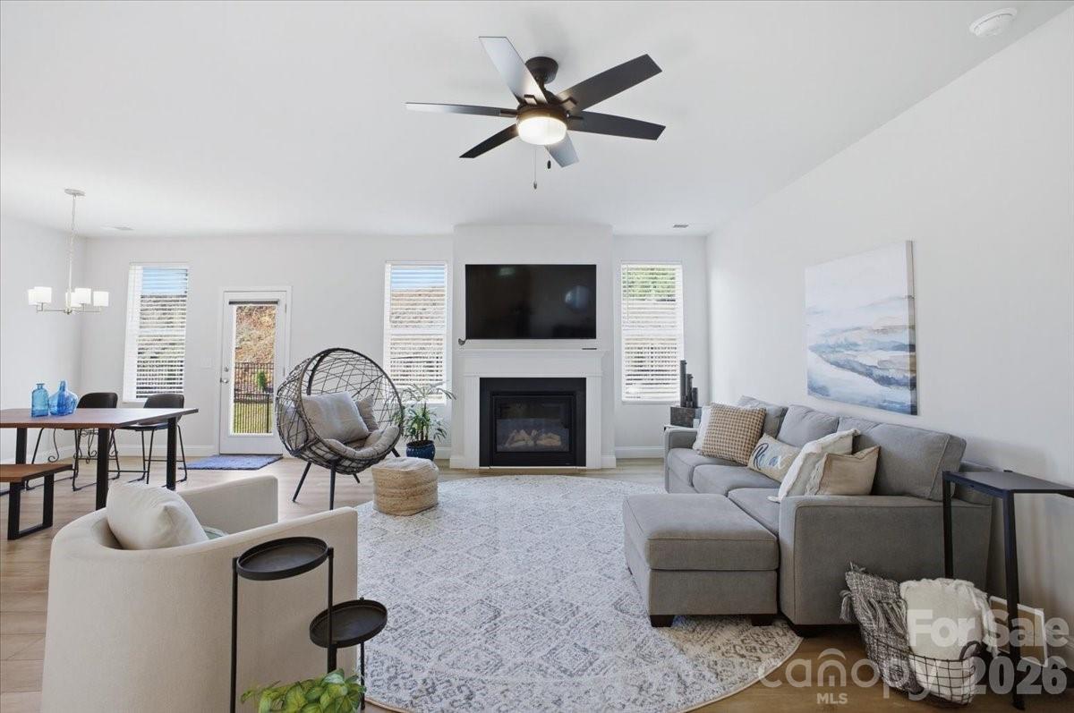 602 Banter Lane Cramerton, NC 28056 - Photo 3 of 33 a living room with furniture a fireplace and a flat screen tv