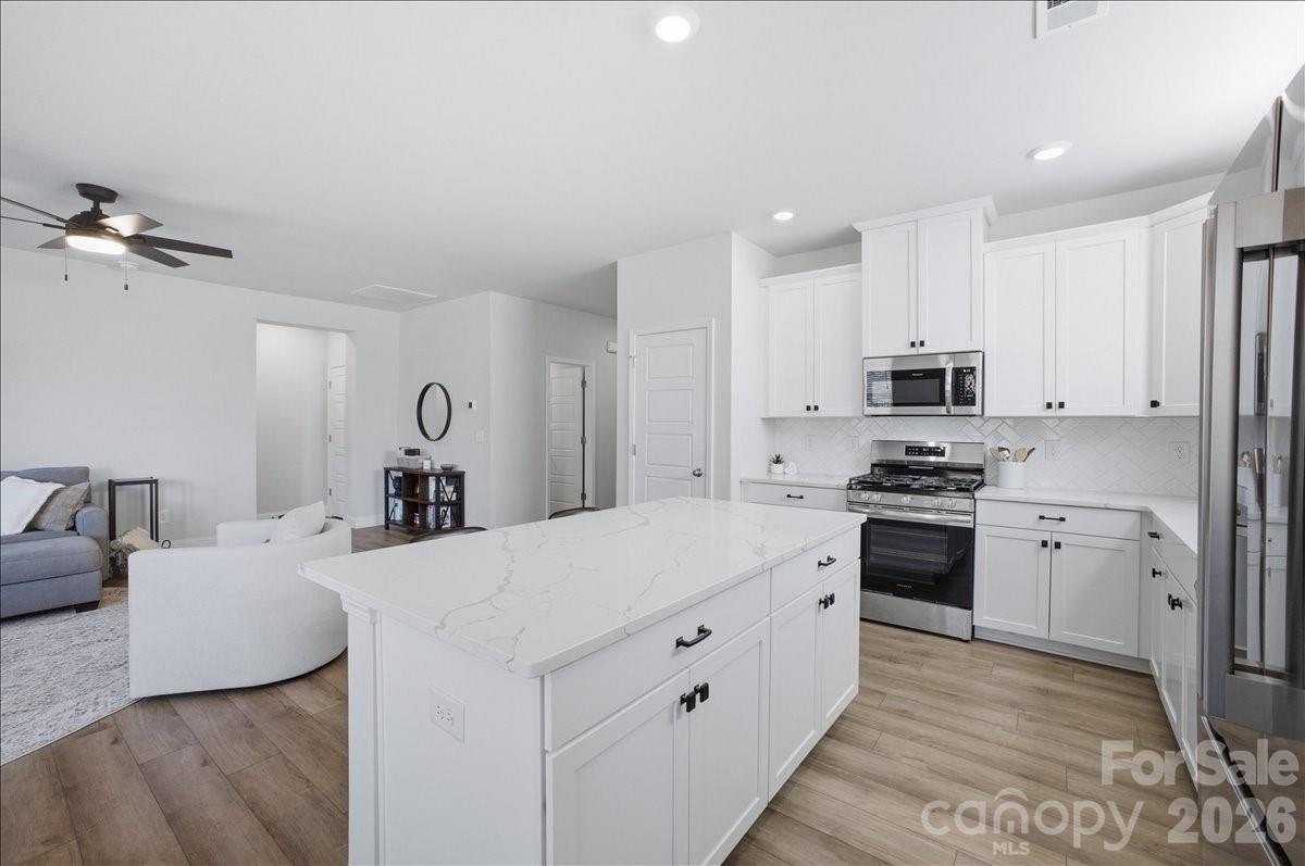 602 Banter Lane Cramerton, NC 28056 - Photo 7 of 33 a large white kitchen with stainless steel appliances