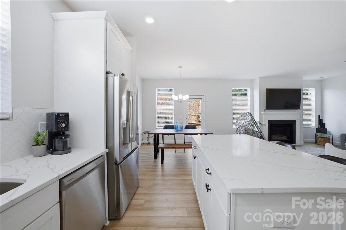 602 Banter Lane Cramerton, NC 28056 - Photo 8 of 33 a large white kitchen with a table and chairs in it