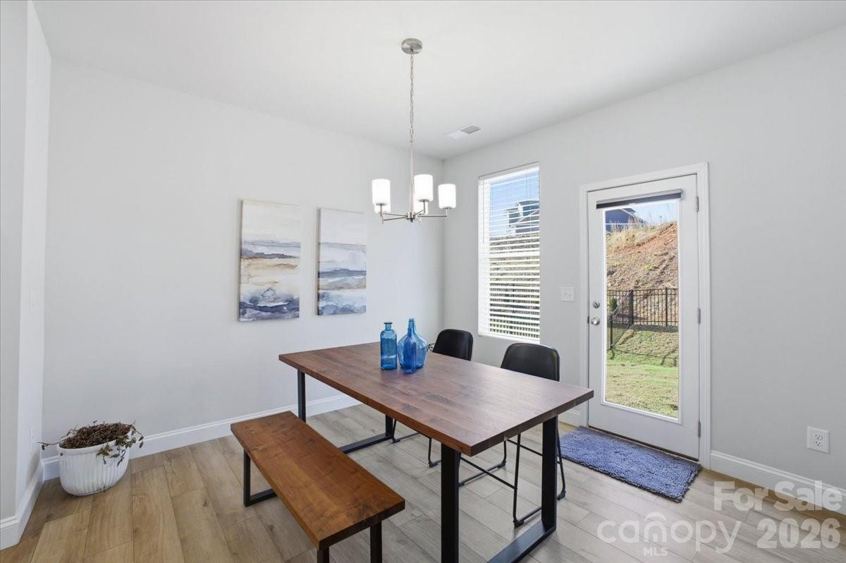 602 Banter Lane Cramerton, NC 28056 - Photo 10 of 33 a view of a dining room with furniture window and wooden floor