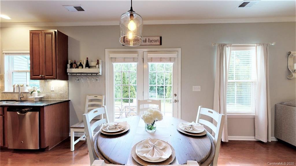 3010 Fallondale Road Waxhaw, NC 28173 - Photo 12 of 44 a kitchen with granite countertop a sink dining table and chairs