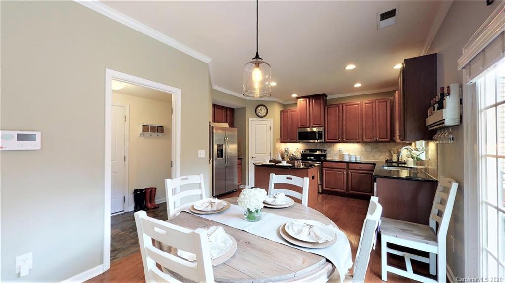 3010 Fallondale Road Waxhaw, NC 28173 - Photo 14 of 44 a view of a dining room with furniture a kitchen and chandelier