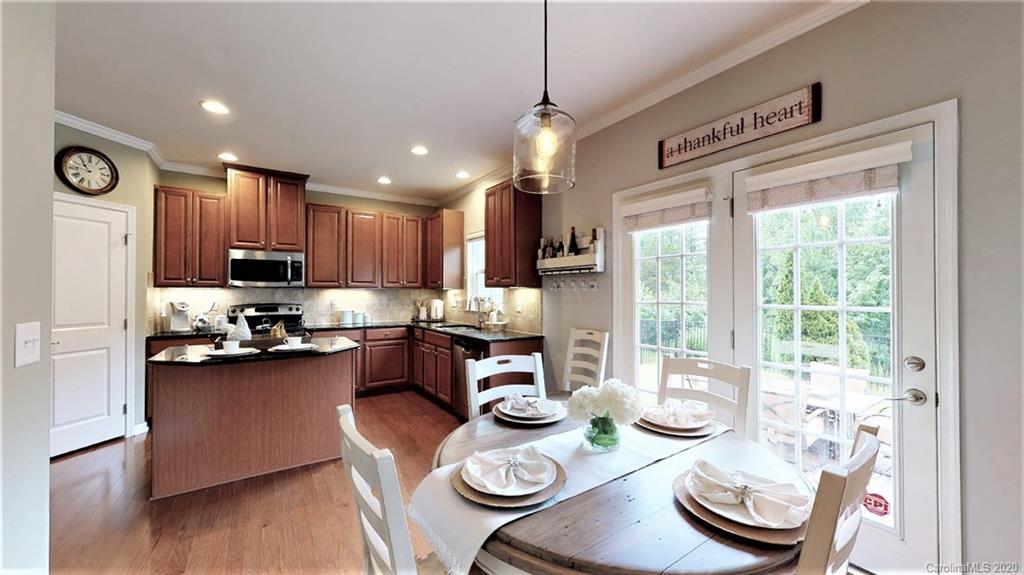 3010 Fallondale Road Waxhaw, NC 28173 - Photo 15 of 44 a kitchen with granite countertop stainless steel appliances a dining table and chairs