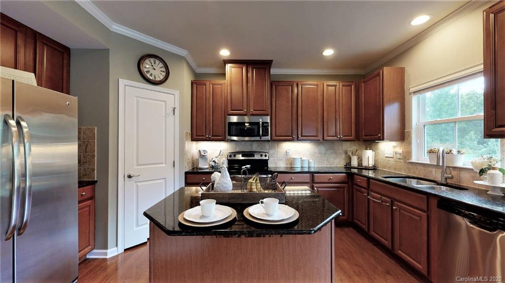 3010 Fallondale Road Waxhaw, NC 28173 - Photo 16 of 44 a kitchen with stainless steel appliances granite countertop a sink stove and refrigerator