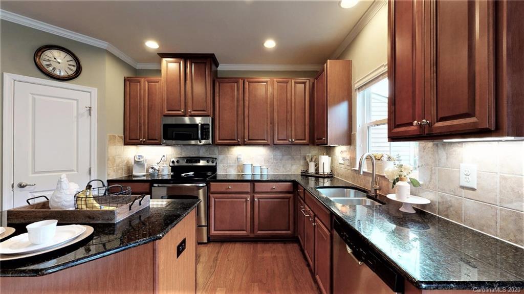 3010 Fallondale Road Waxhaw, NC 28173 - Photo 17 of 44 a kitchen with stainless steel appliances granite countertop a sink stove and refrigerator
